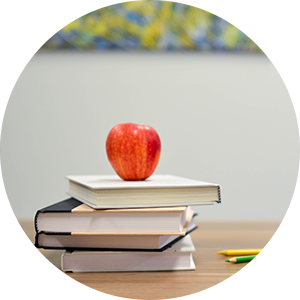An apple on top of stack of books